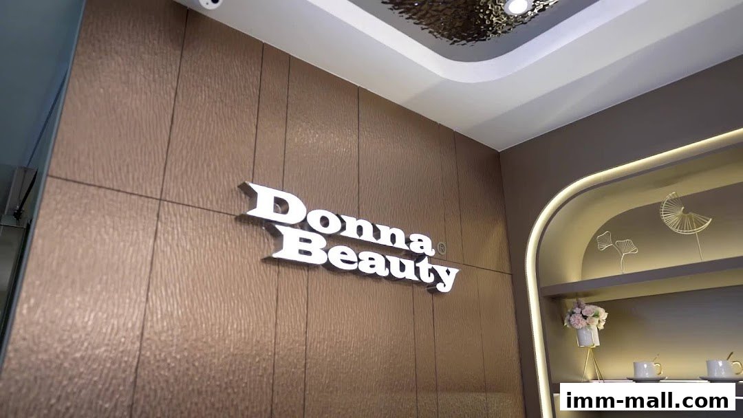 The illuminated "Donna Beauty" sign is mounted on a textured wall with decorative shelving.