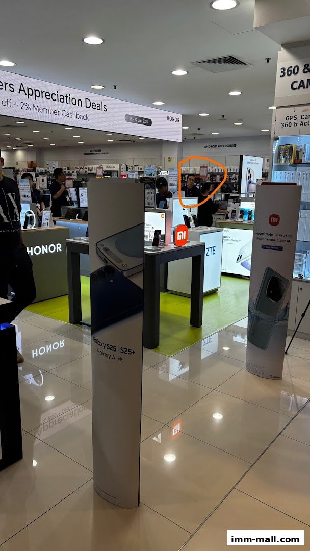 Interior of a tech store showcasing mobile phones and accessories with promotional signage.