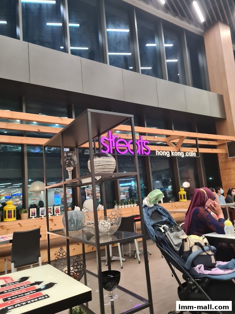 Interior view of Streats Hong Kong Cafe with seating, decor, and customers.