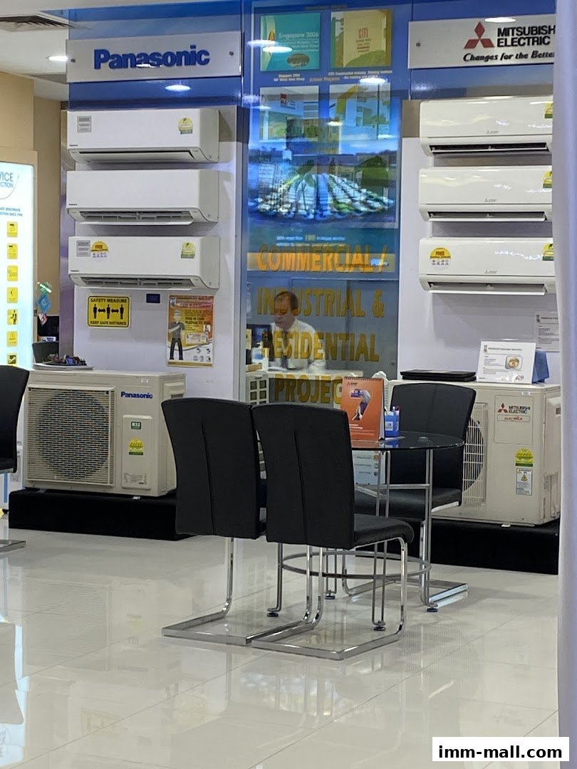A retail display featuring Panasonic and Mitsubishi Electric air conditioners with seating area.