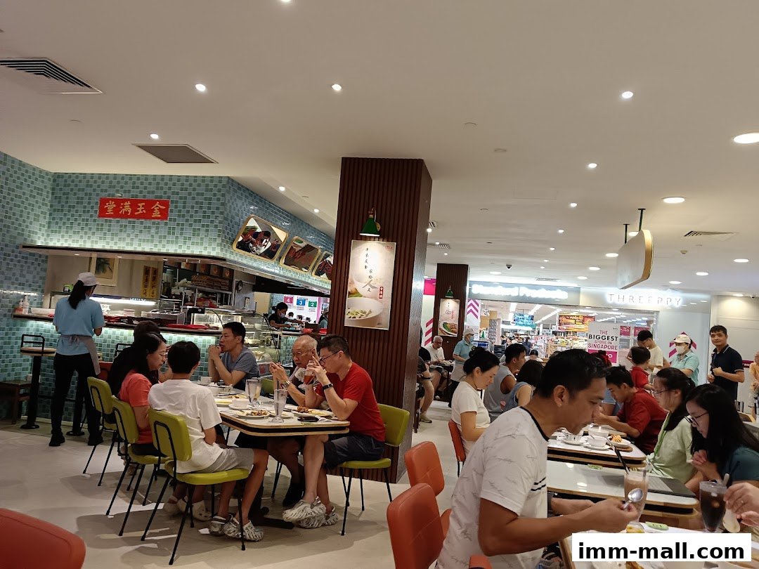 People dining at tables inside a busy Hong Kong-style tea room.