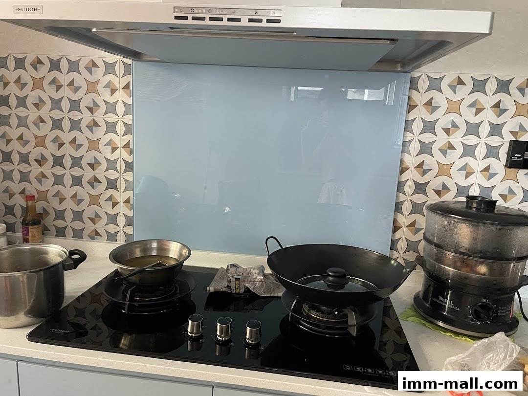 A kitchen scene with a stovetop, cookware, and a steamer.