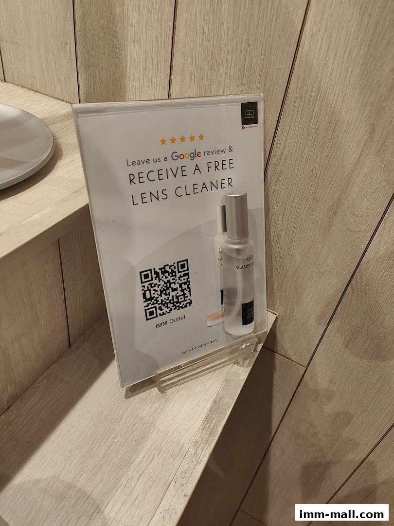 A sign offering a free lens cleaner for a Google review at OWNDAYS IMM Outlet.
