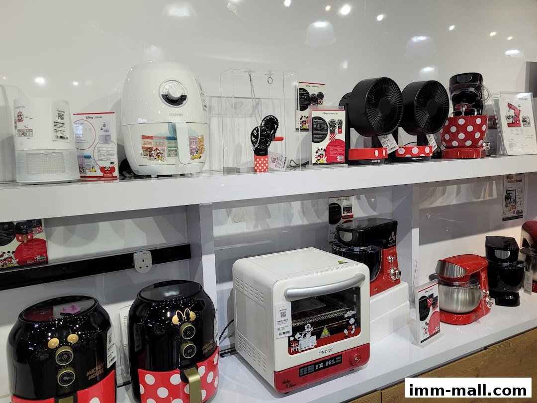 A display of various kitchen appliances, including air fryers and stand mixers, many featuring Disney's Mickey Mouse theme.