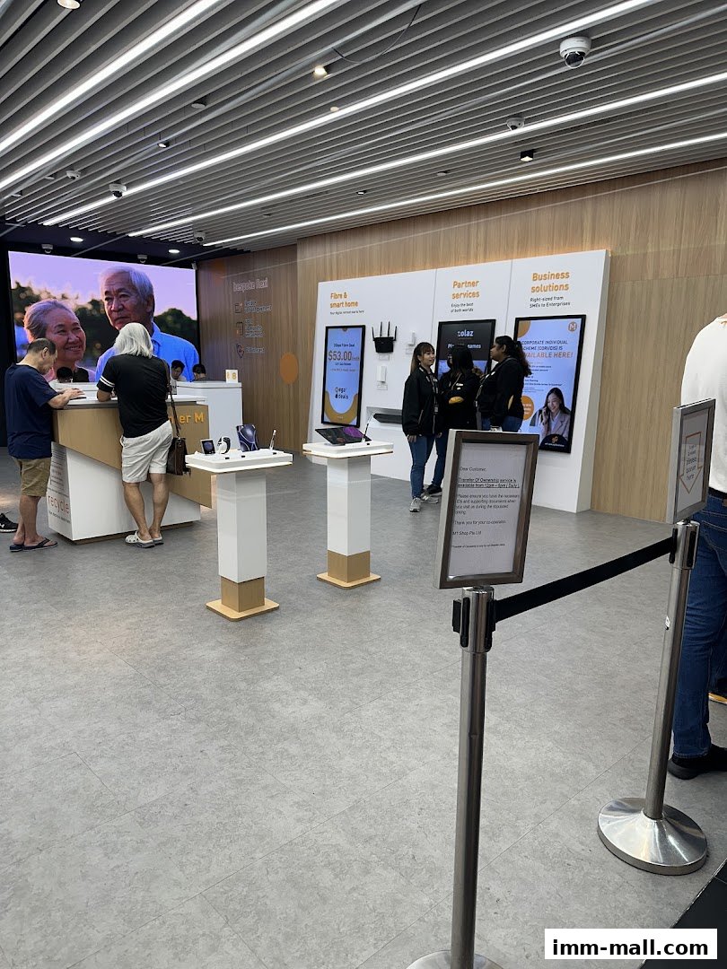Interior view of a modern phone shop with displays and staff assisting customers.
