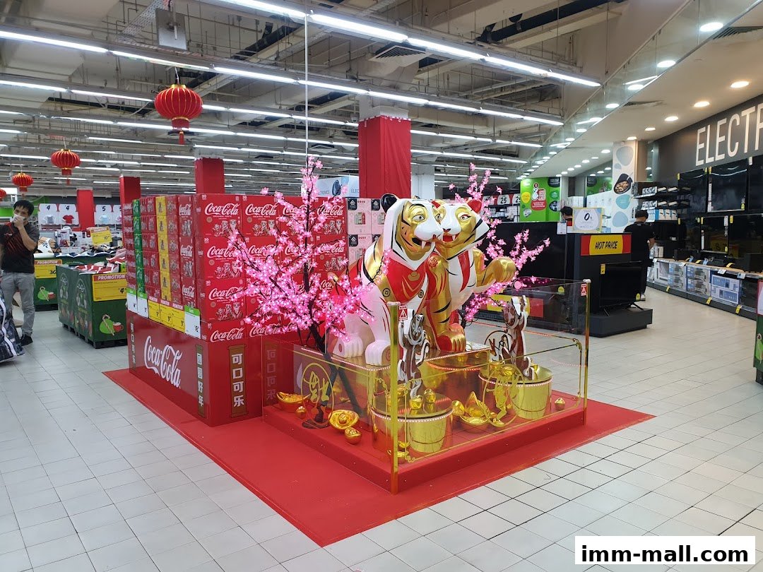 Giant Supermarket interior with festive decorations, including Coca-Cola displays and tiger statues.