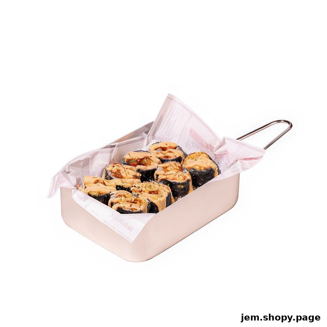 A close-up of a bento box filled with crispy chicken rolls drizzled with sauce.