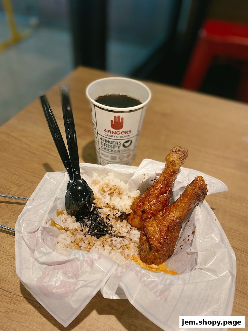 Crispy chicken drumsticks with rice and a drink from 4 Fingers Crispy Chicken.