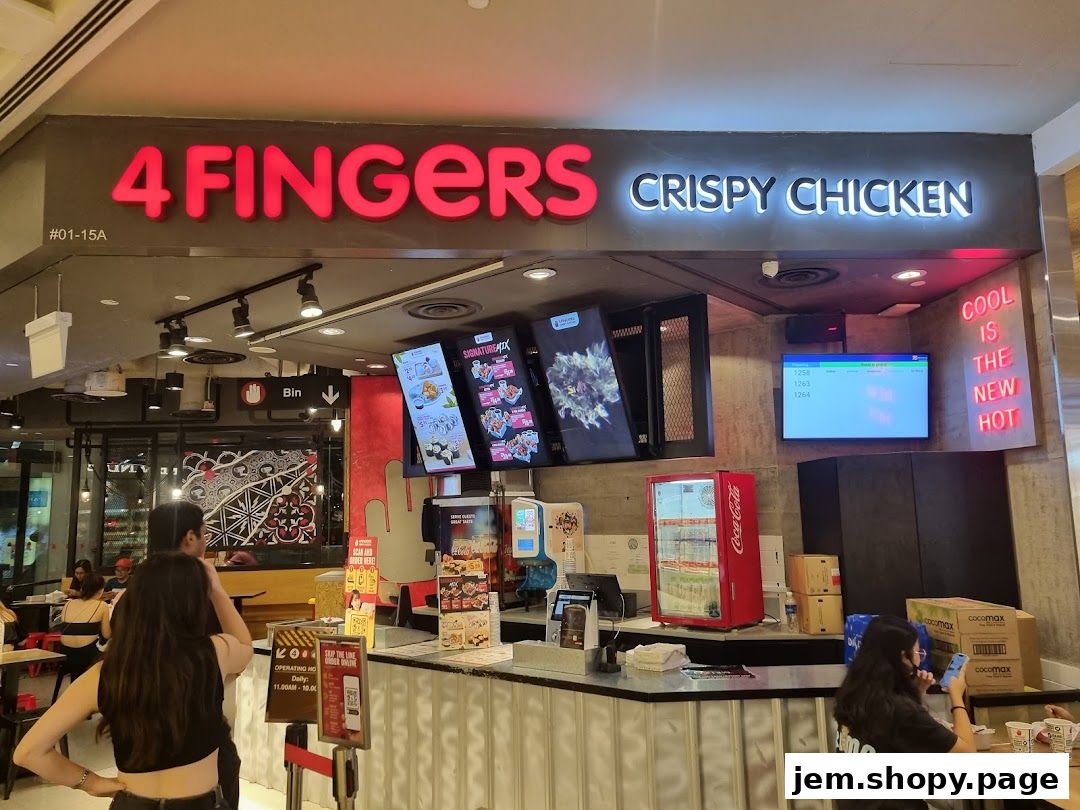 The storefront of 4 Fingers Crispy Chicken with a counter, menu screens, and seating area.