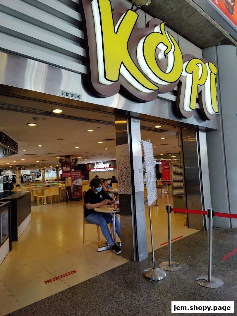 The entrance of Ah Ma Chi Mian with a person sitting at a table outside.
