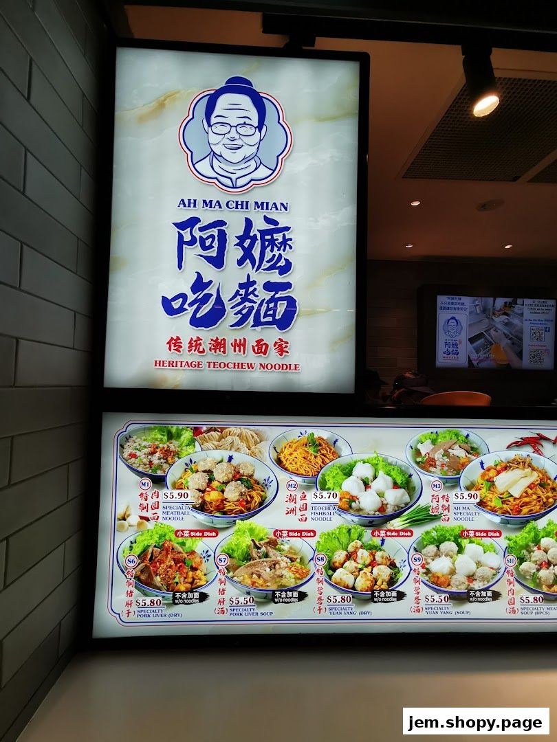 A brightly lit menu board for Ah Ma Chi Mian, showcasing various noodle dishes and side dishes.
