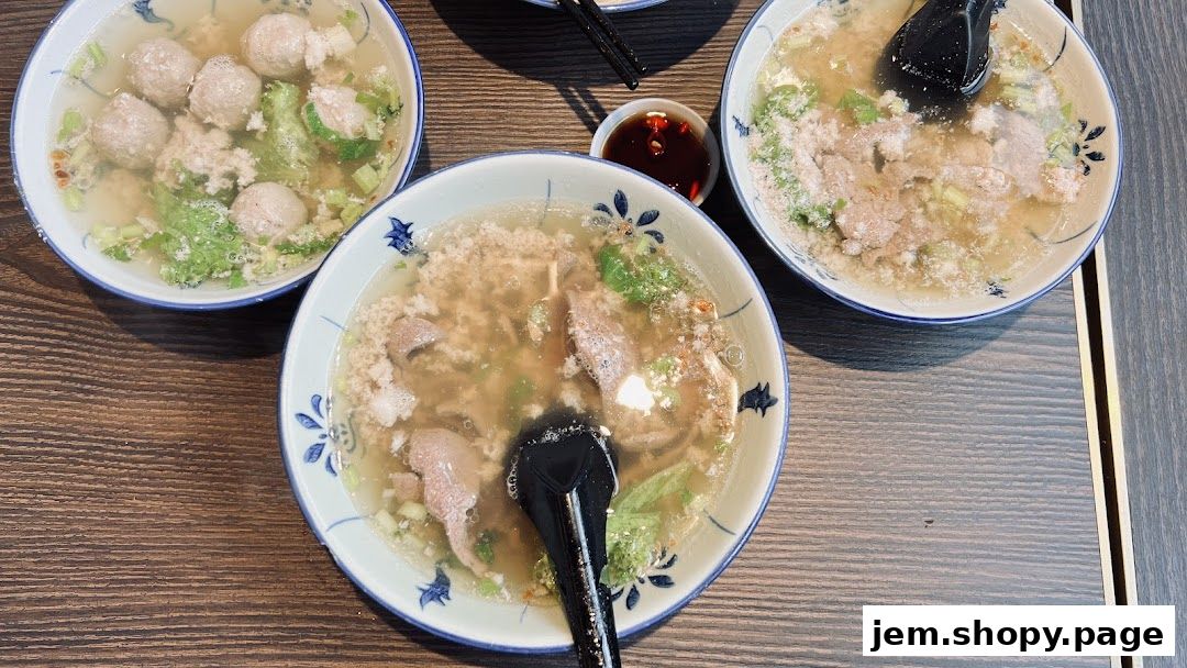 Three bowls of soup with meatballs and minced meat, served with a small dipping sauce.