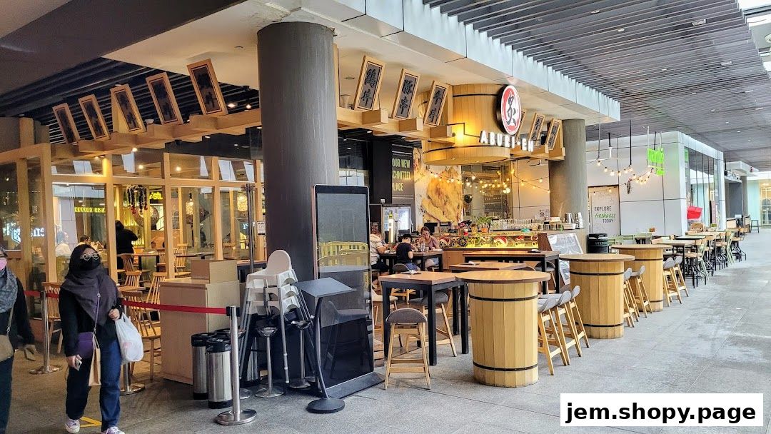 The exterior of Aburi-EN Jem restaurant with outdoor seating and a visible storefront.