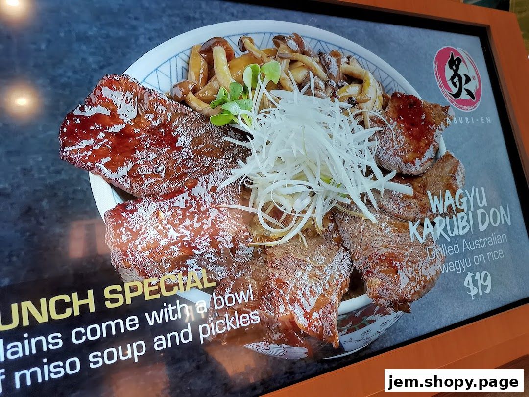 A close-up of a Wagyu Karubi Don dish with grilled meat, mushrooms, and rice.