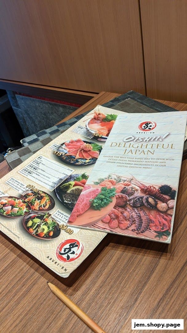 A menu from Aburi-EN Jem featuring Japanese dishes with fresh seafood and ingredients.