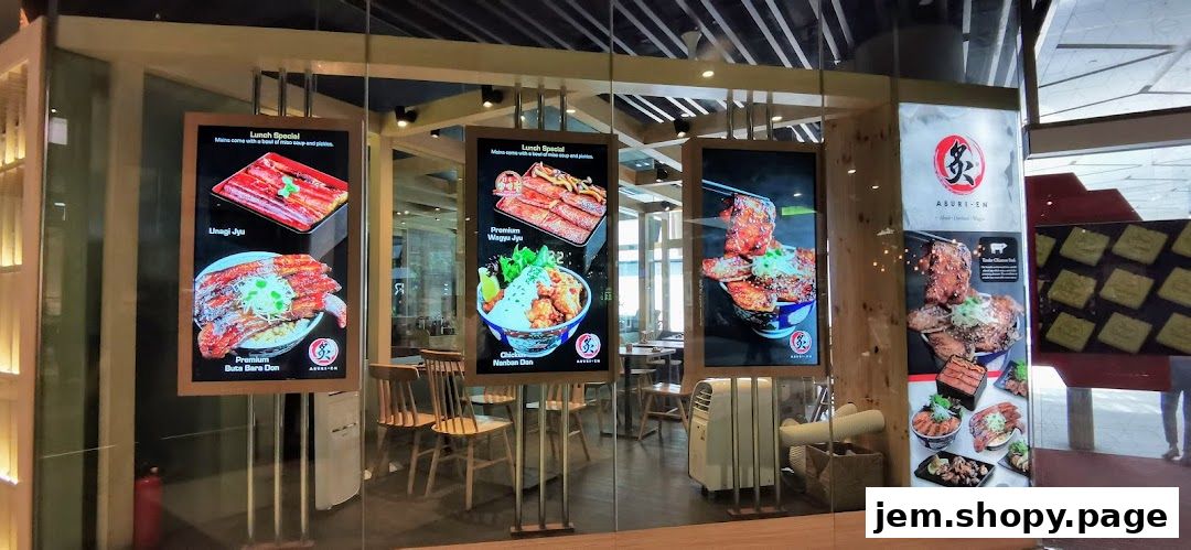 Aburi-EN Jem shop front displaying digital menus with various Japanese dishes.