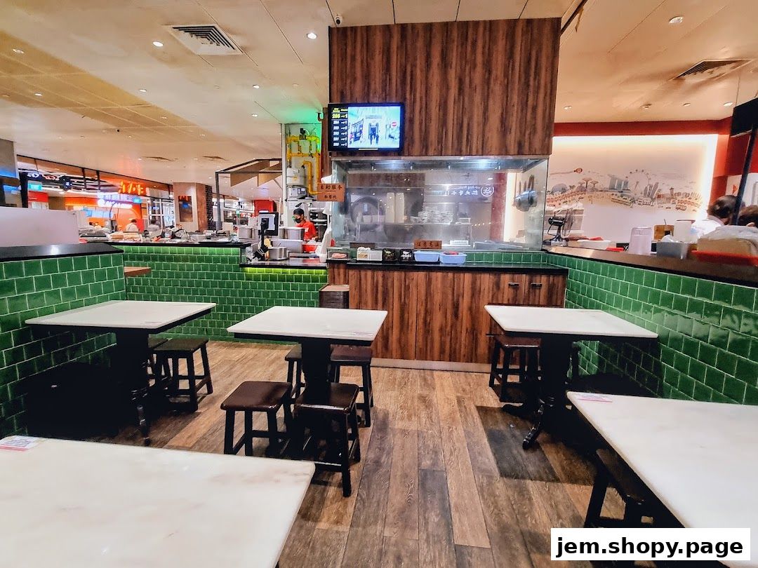 Interior view of Ah Chiangs Traditional Porridge with tables, stools, and kitchen counter.