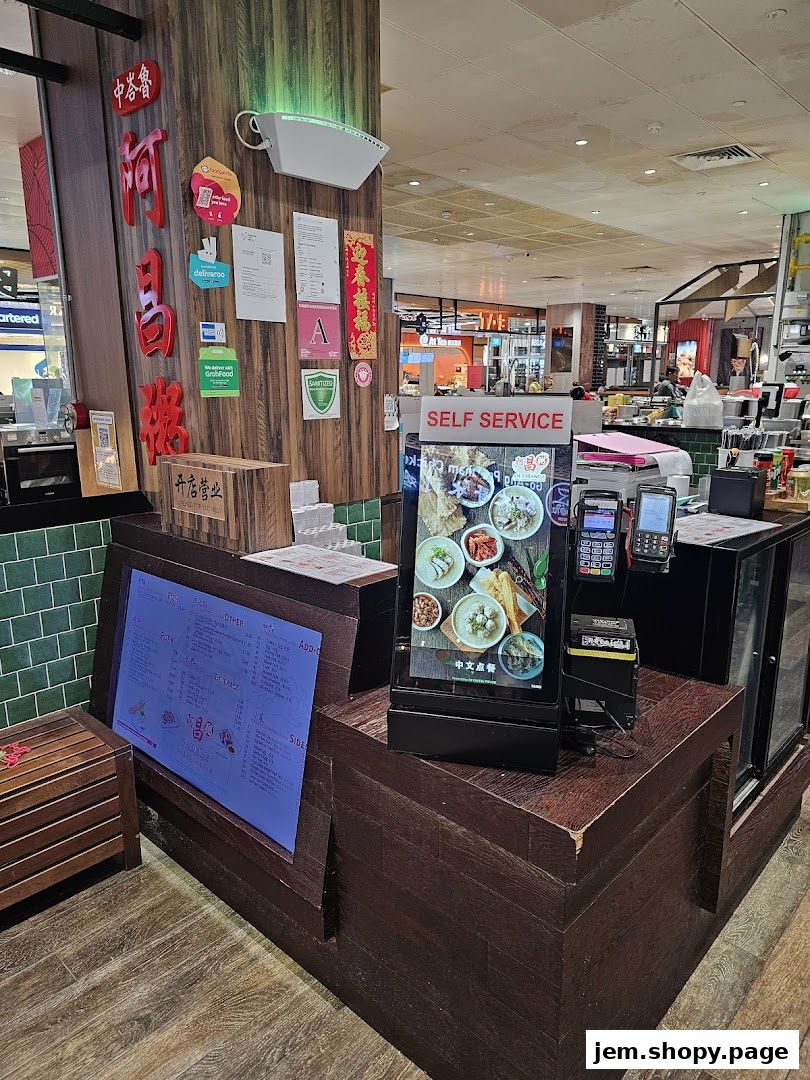 Self-service counter at Ah Chiangs Traditional Porridge with digital menu and payment terminals.