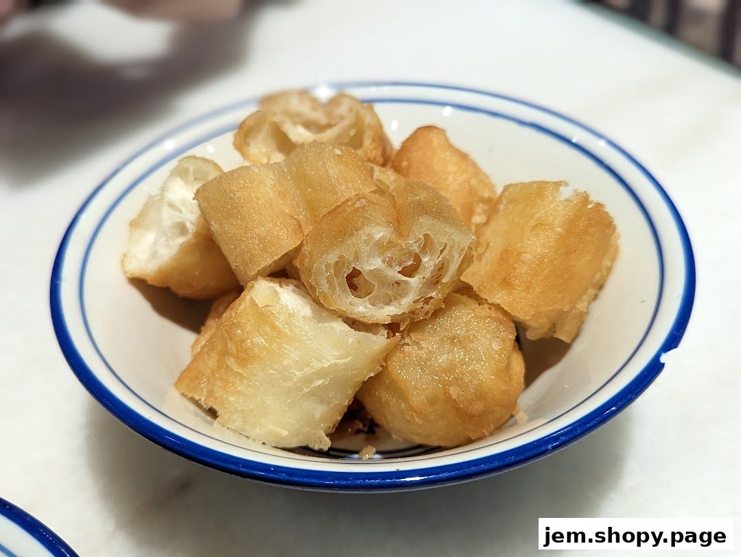A bowl of golden fried dough sticks, a popular breakfast item.