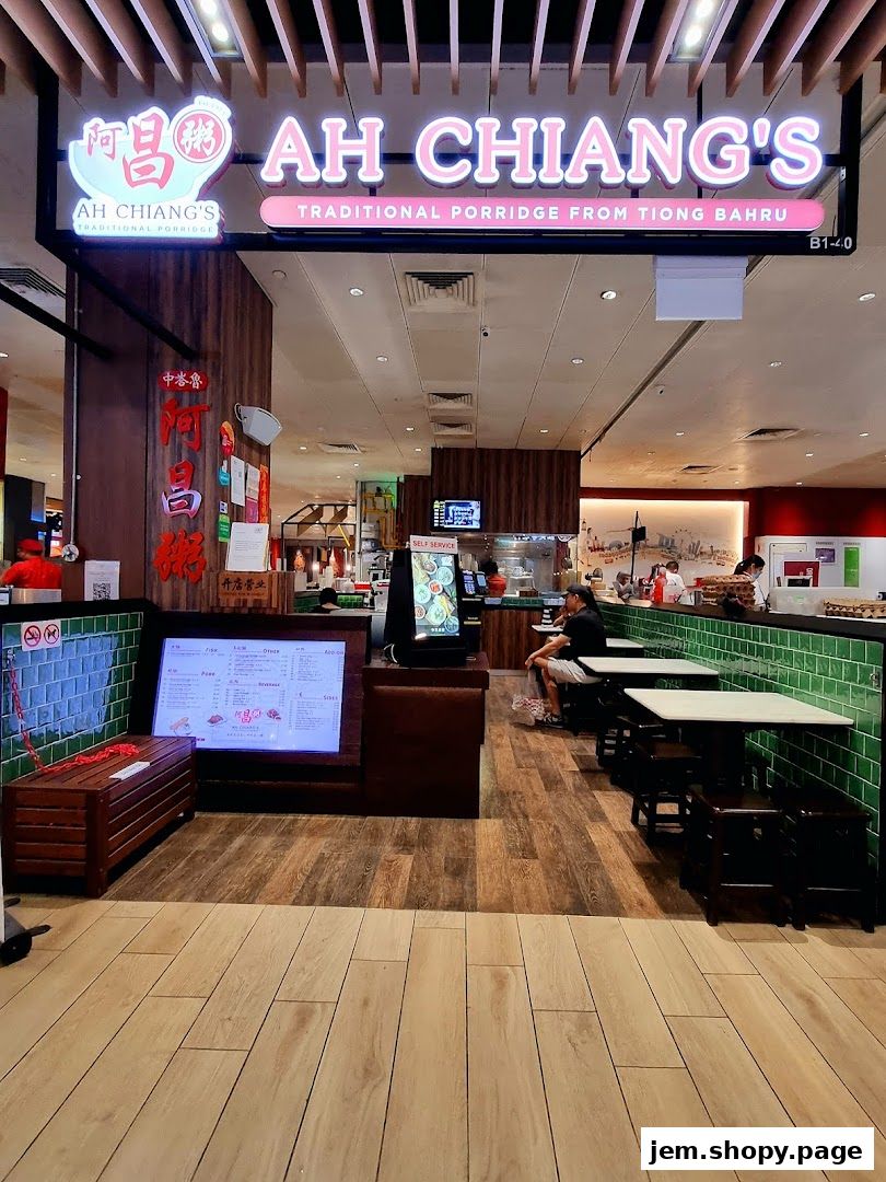 The entrance of Ah Chiang's Traditional Porridge shop with a menu display and seating area.