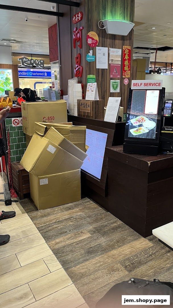 A digital menu board displays food items and prices at Ah Chiangs Traditional Porridge.