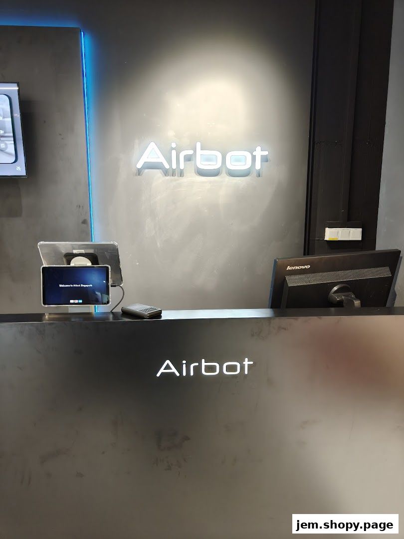 The Airbot store features a modern counter with a neon sign and digital displays.