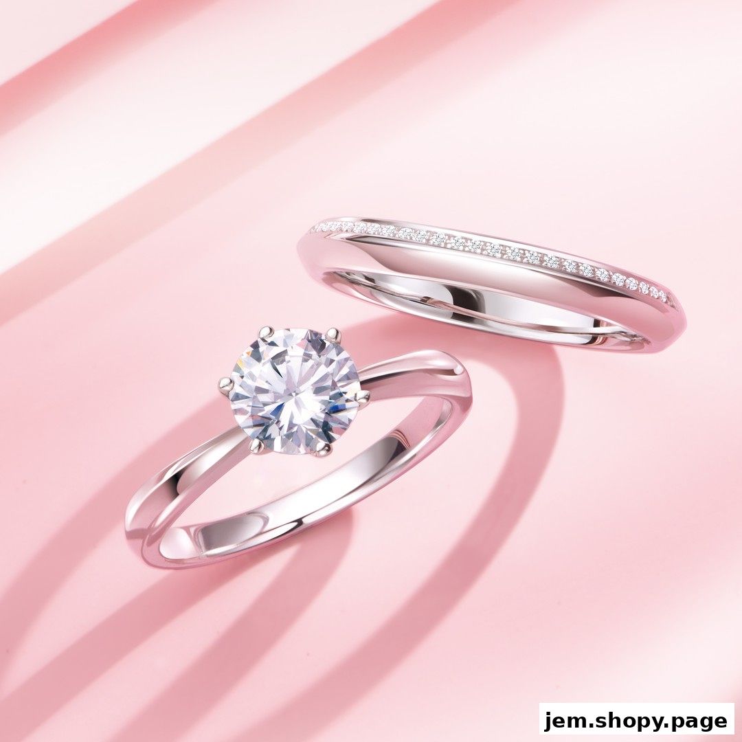 A close-up shot of a diamond engagement ring and a wedding band on a pink background.