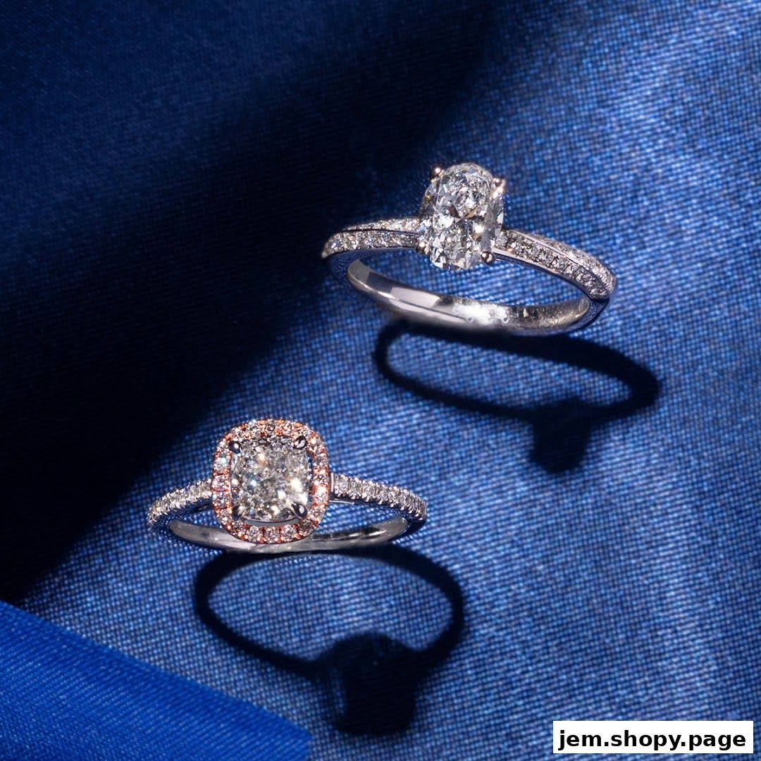 Two exquisite diamond engagement rings displayed on a textured blue fabric.