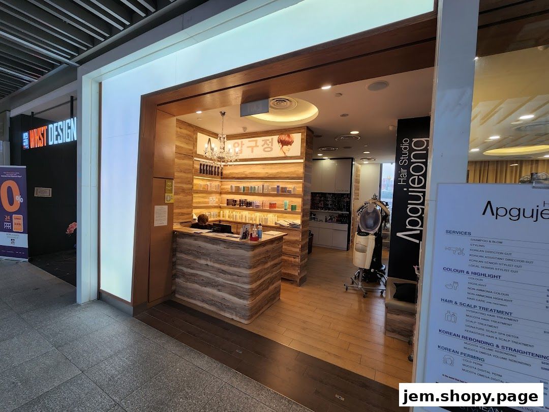 Entrance and interior of Apgujeong Hair Studio, showcasing a reception desk and product shelves.