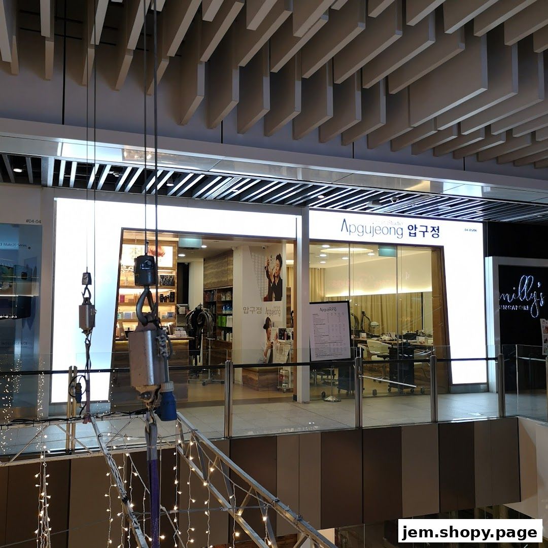 Exterior view of Apgujeong Hair Studio with bright signage and interior visible.