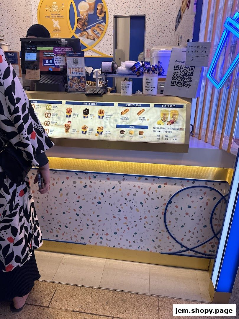 Auntie Anne's pretzel shop counter displaying menu items and beverages.