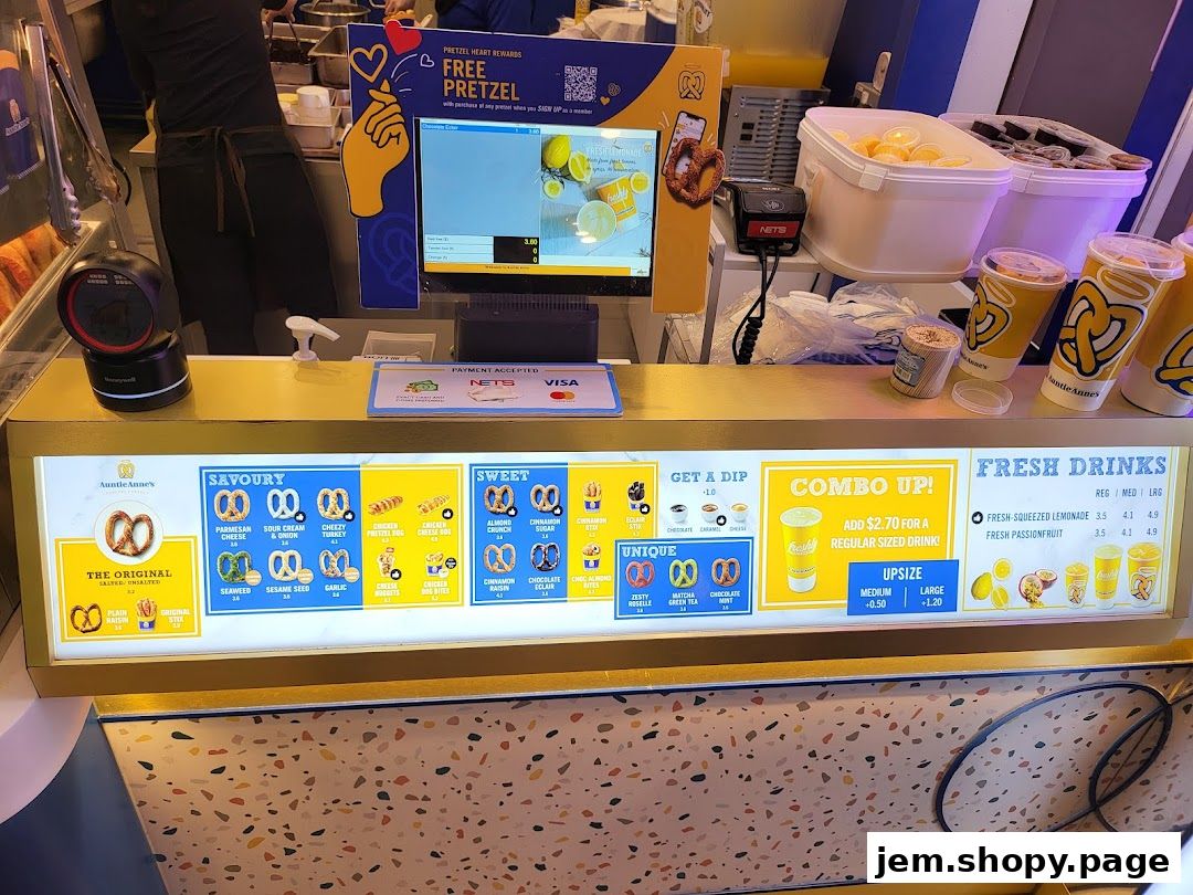Auntie Anne's pretzel shop counter displaying menu items and drinks.