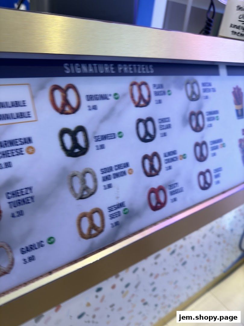 A menu board displaying various signature pretzel flavors and their prices.