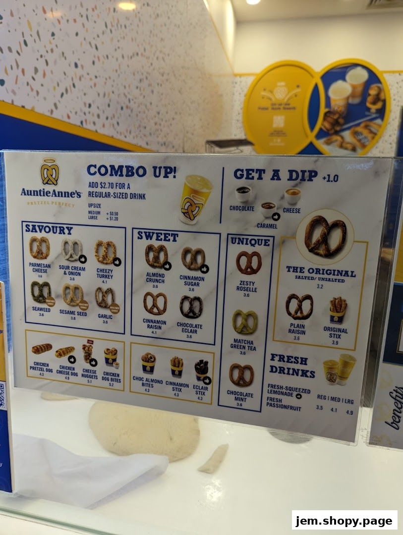 Auntie Anne's menu board displaying savory, sweet, unique pretzels, stix, and drinks.