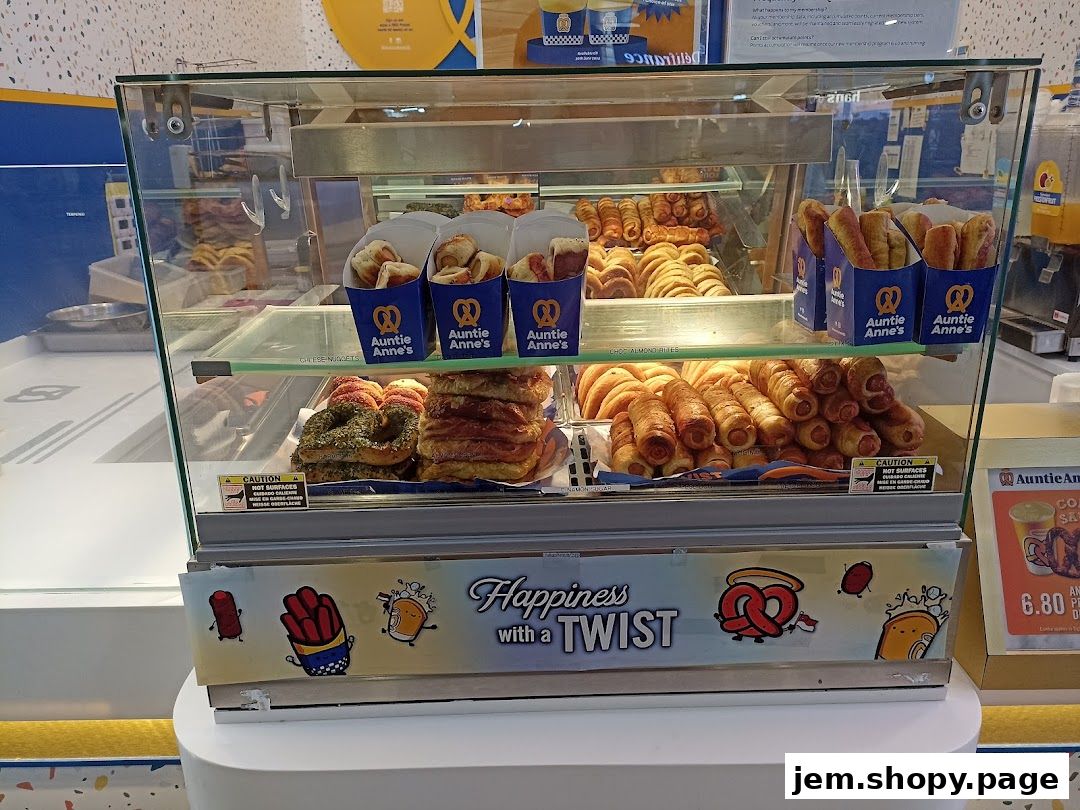 A display case filled with various Auntie Anne's pretzel products and drinks.