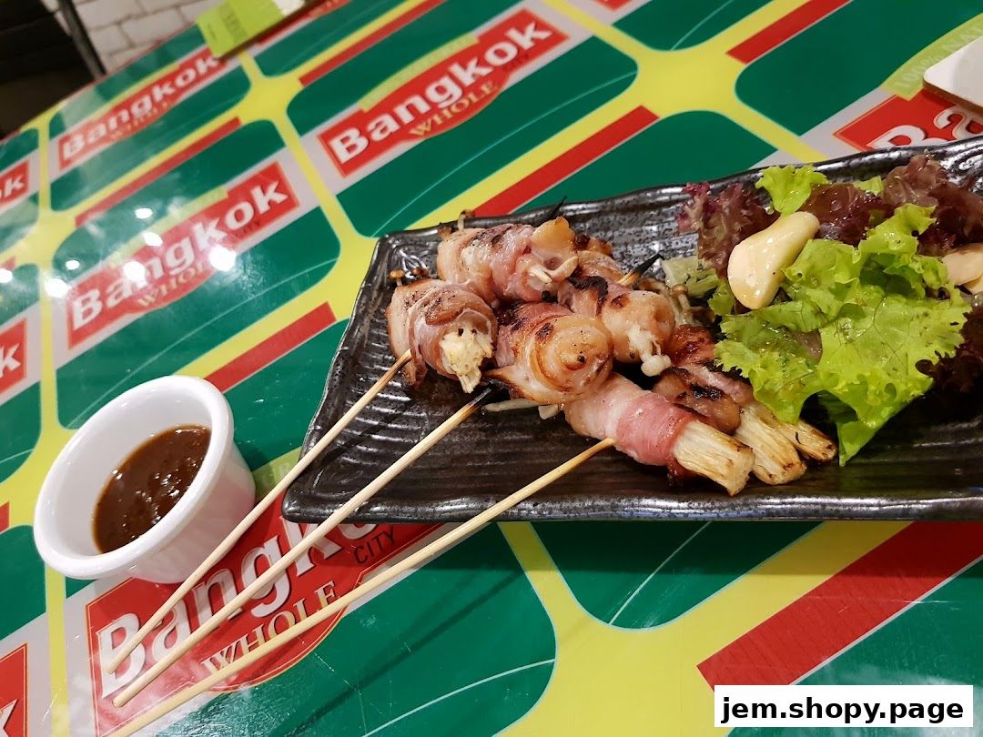 Bacon-wrapped skewers with enoki mushrooms and a side salad served at Bangkok Jam.