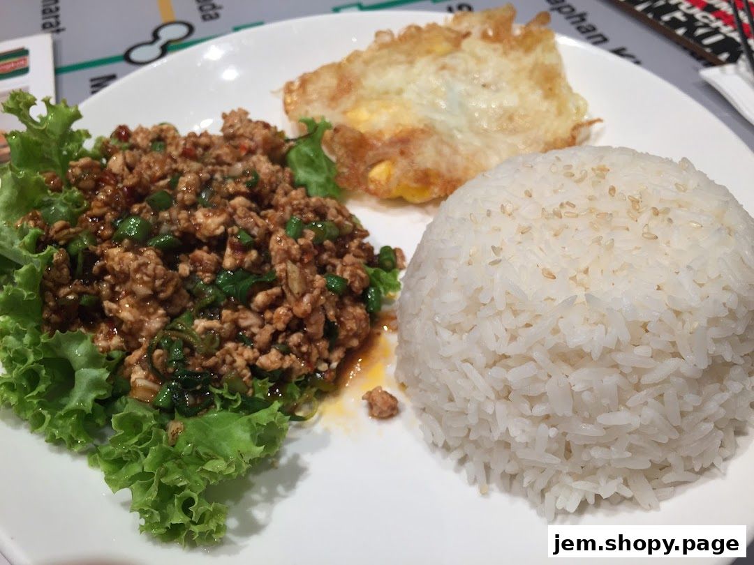 A plate of Thai basil minced pork with rice and a fried egg.