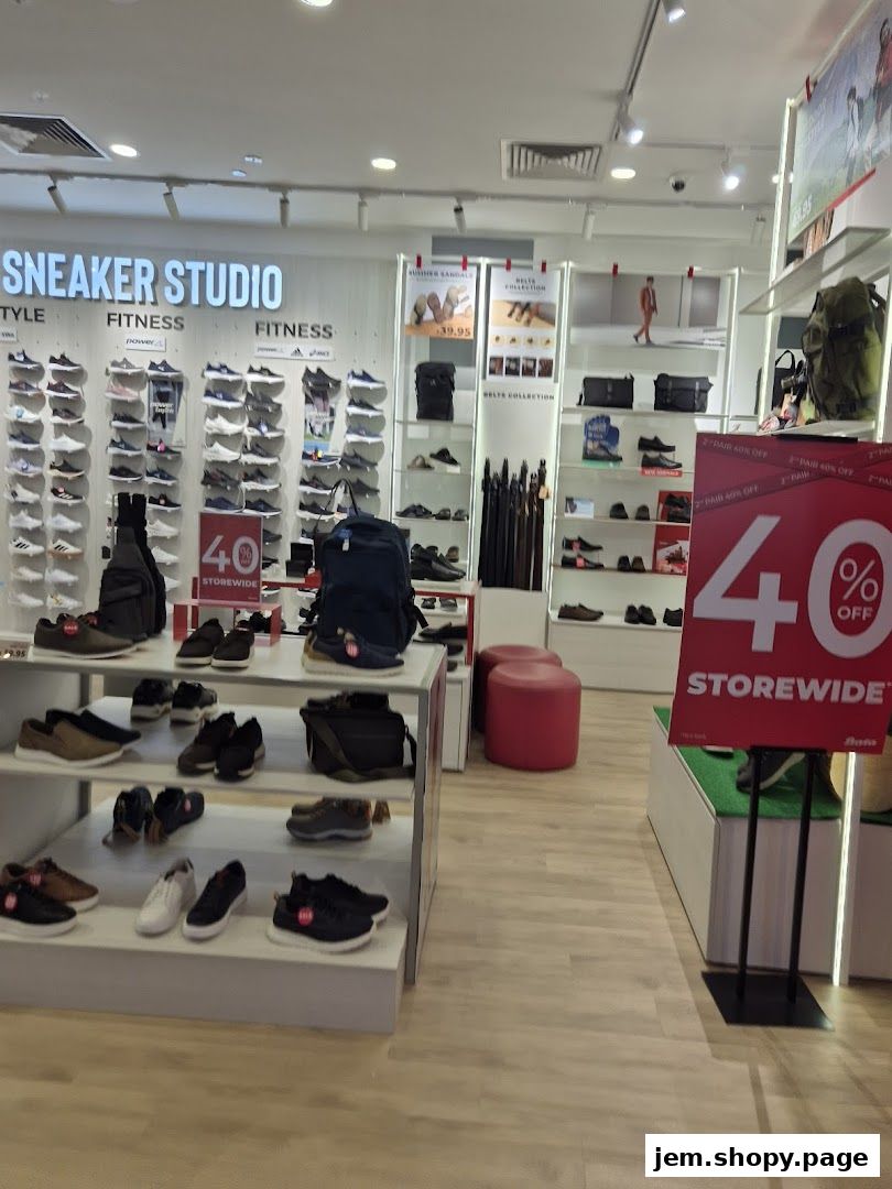 Interior view of a Bata shoe store showcasing sneakers, sandals, and accessories with a 40% off sale.