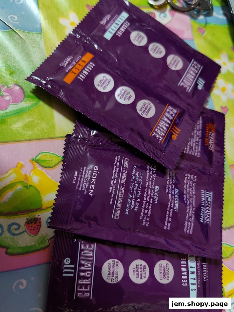 Several small purple sachets of Bioken Ceramide shampoo and mask are scattered on a colorful surface.