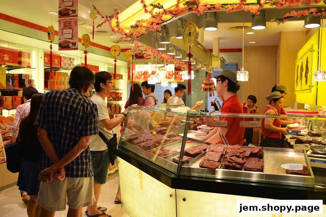 Customers browse bak kwa at a brightly lit Bee Cheng Hiang store with festive decorations.