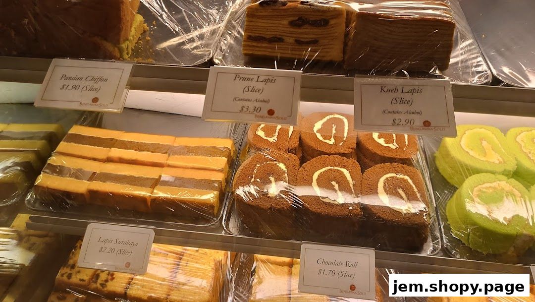 A display of various cakes and rolls with price labels at Bengawan Solo.