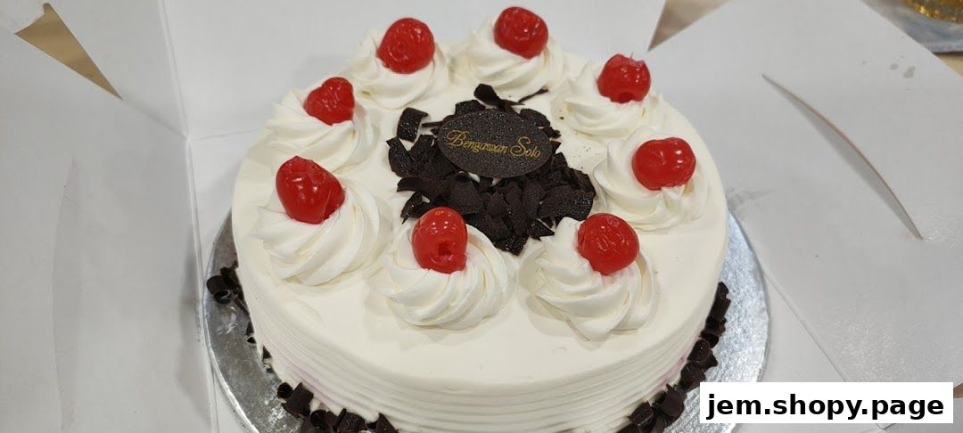 A beautifully decorated cake from Bengawan Solo, topped with cream, cherries, and chocolate shavings.