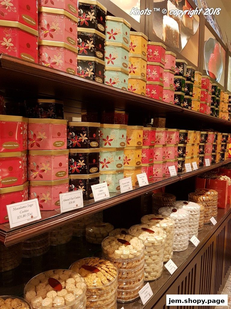 Shelves filled with decorative tins and containers of assorted cookies at Bengawan Solo.