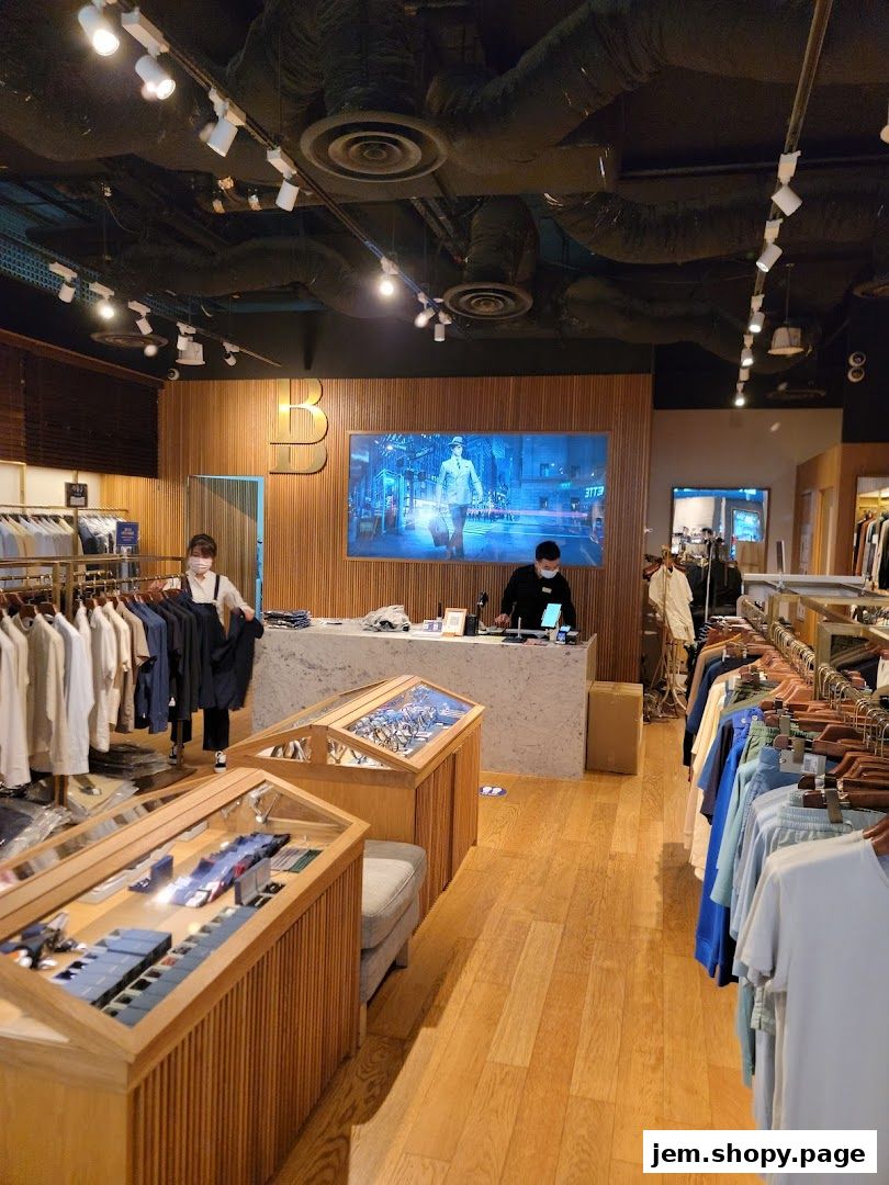 Interior of a Benjamin Barker clothing store with displays and staff.