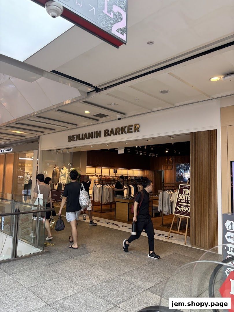 Benjamin Barker store entrance with clothing displays and shoppers walking by.