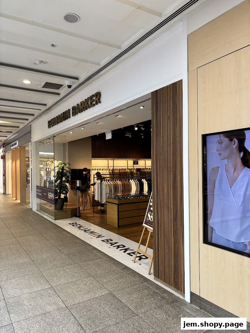 Benjamin Barker store entrance with clothing displays and a digital advertisement.