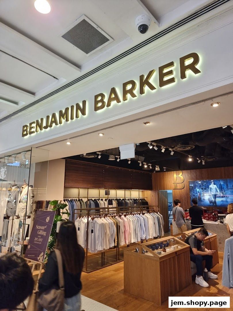 Benjamin Barker store interior showcasing men's shirts and suits with a sale sign.