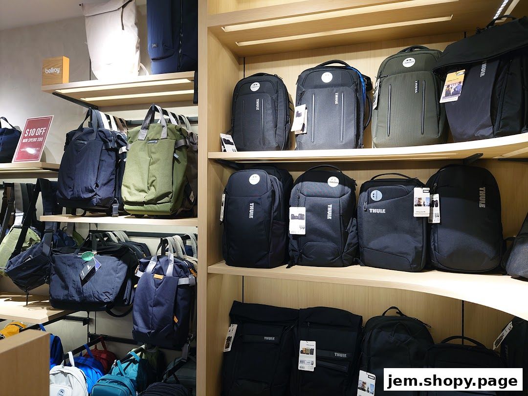 A retail shop display featuring a variety of backpacks, duffel bags, and travel bags.