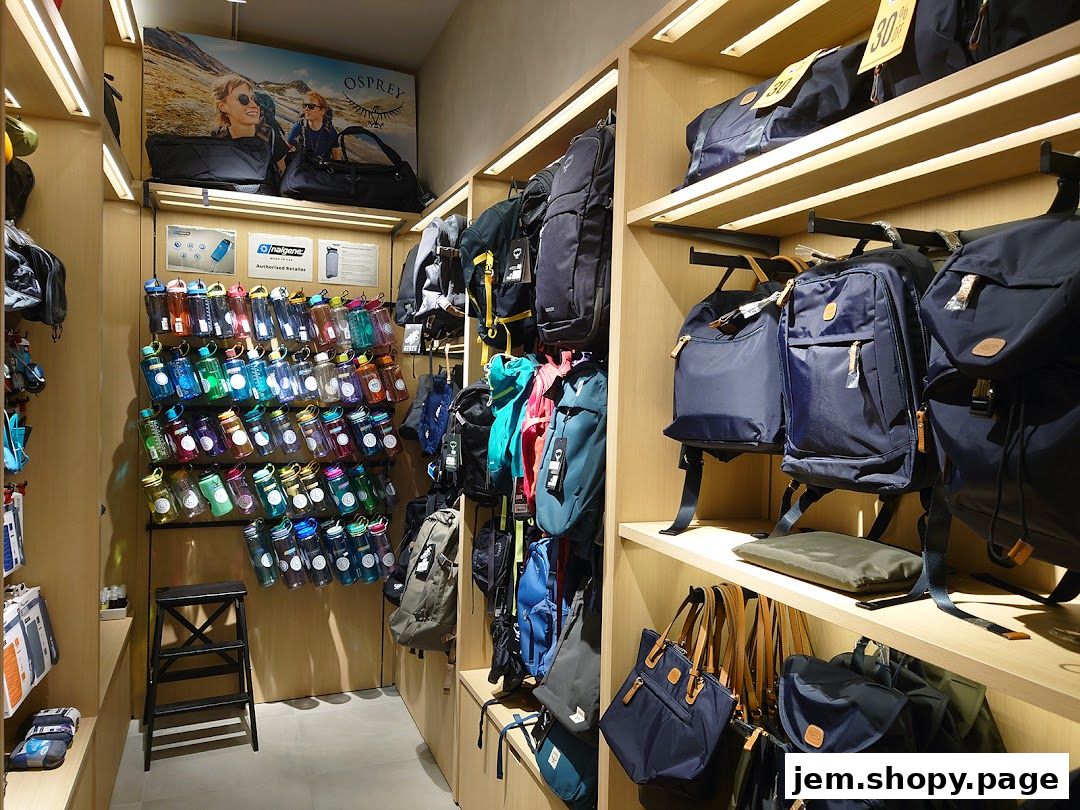 A retail shop interior displaying a wide selection of backpacks, duffel bags, and water bottles.