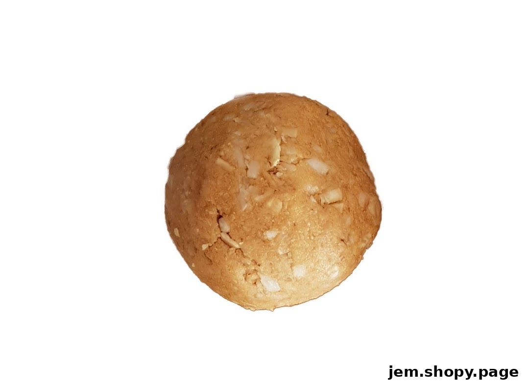 A close-up shot of a round, golden-brown cookie with visible chunks of nuts or chocolate chips.